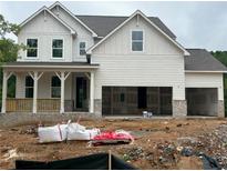 Two-story white home featuring a covered porch and unfinished two-car garage at 363 Riverwood Pass, Dallas, GA 30157