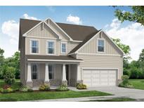 Charming two-story home with a covered porch and a two-car attached garage on a beautifully landscaped lot at 363 Riverwood Pass, Dallas, GA 30157