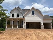 Stunning two-story new construction home with a welcoming front porch and attached two car garage at 363 Riverwood Pass, Dallas, GA 30157