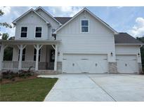 Charming two-story home featuring a three-car garage, covered porch, and white siding at 363 Riverwood Pass, Dallas, GA 30157