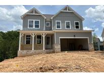 Charming two-story home featuring a covered porch, two-car garage, and inviting curb appeal at 373 Riverwood Pass, Dallas, GA 30157