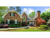 Charming brick home with manicured lawn and lush landscaping at 2675 Misty Morning Ln, Roswell, GA 30076