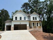 New construction of a two story home with white siding, brick accents and a two car garage at 30 Riverrock Trl, Dallas, GA 30157