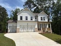 Charming two-story home with white siding, a spacious driveway, and a two-car garage at 30 Riverrock Trl, Dallas, GA 30157