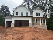 New construction, two-story home with white siding, brick accents, and a two-car garage at 30 Riverrock Trl, Dallas, GA 30157