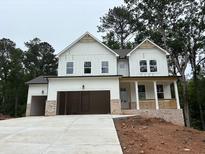New construction home with white siding, attached two-car garage, and inviting front porch at 30 Riverrock Trl, Dallas, GA 30157