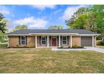 Charming brick home with a well-manicured lawn and inviting front entrance at 1857 Taffeta Trl, Lithonia, GA 30058