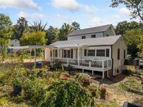 Well-maintained home featuring a spacious back deck and carport, surrounded by a lush garden at 717 Chamberlain Sw Cir, Marietta, GA 30008