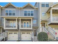 Charming townhome showcasing a two-car garage and an inviting covered balcony at 2015 Liberty Nw Ct, Atlanta, GA 30318