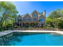 Stunning backyard pool and deck with a spacious two-story home in a private, lush setting at 20 Rivercreek Xing, Kingston, GA 30145