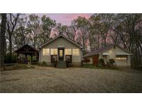 Charming home features a symmetrical design, and a separate garage with a covered walkway at 5 Colonial Club Se Dr, Acworth, GA 30102