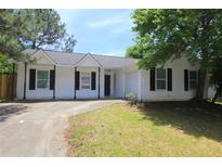 Charming single-story home with a black roof, black shutters, and a well-maintained front yard at 6269 Marbut Farms Rd, Lithonia, GA 30058