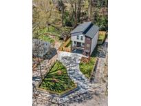 Stunning aerial view of a modern two-story home with well-manicured lawn and driveway at 608 S Evelyn Nw Pl, Atlanta, GA 30318