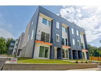 Modern townhome featuring a stylish facade with multiple windows, small balconies, and well-maintained landscaping at 2029 Memorial Dr # 32, Atlanta, GA 30317