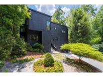 Stunning contemporary home with black exterior and lush landscaping at 4 W Wesley Nw Rdg, Atlanta, GA 30327