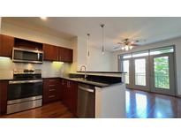 Modern kitchen featuring stainless steel appliances and dark wood cabinetry at 390 17Th Nw St # 4037, Atlanta, GA 30363