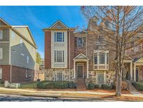 Charming townhome with a brick and stone facade, front yard, and inviting entrance at 3901 High Dove Sw Way # 17, Smyrna, GA 30082