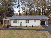 Charming renovated home with a freshly painted white brick exterior and a modern, attached garage at 1970 Capri Dr, Decatur, GA 30032