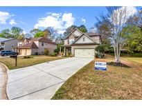 Charming two-story home featuring a stone and siding exterior with a well-maintained lawn at 635 Crosswinds Cir, Marietta, GA 30008