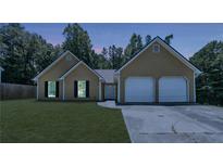 Charming single-story home featuring a two-car garage and well-maintained lawn at 6445 Marsham Dr, Atlanta, GA 30349