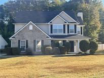 Charming two-story home with a brick and siding facade and well-manicured landscaping at 2013 Reserve Pkwy, Mcdonough, GA 30253