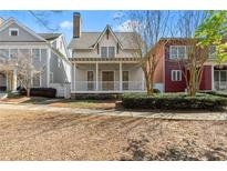 Charming two-story home with a welcoming front porch and manicured landscaping at 3180 Ashton Old Rd, Douglasville, GA 30135