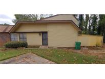 Cozy home with a front yard needing TLC and a fenced-in back yard at 3223 Strawberry Ln, Decatur, GA 30034