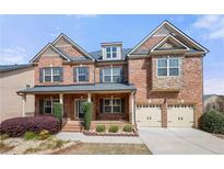 Beautiful two-story brick home featuring a welcoming front porch and a two-car garage at 3750 Lake Haven Way, Atlanta, GA 30349