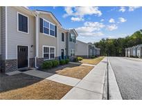 Charming townhome exteriors featuring neutral tones, brick accents, and well-maintained landscaping at 310 Ashigan St, Union City, GA 30291