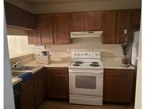Standard kitchen featuring wooden cabinets and a white electric range at 470 Teal Ct, Roswell, GA 30076