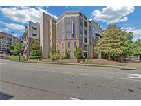 Contemporary condo building with neat landscaping, street view and a bright blue sky at 390 17Th Nw St # 4048, Atlanta, GA 30363