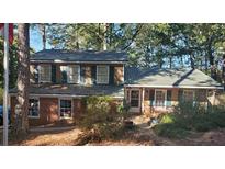 Charming two-story home featuring a mix of brick and stone, nestled among mature trees at 3905 Hunters Chase, Conyers, GA 30094
