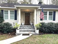 Charming home featuring a stone stairway leading to a dark wood front door at 4002 Wieuca Ne Rd, Atlanta, GA 30342