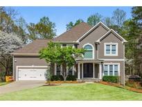 Charming two-story home with well-maintained lawn and attached two-car garage at 1165 Lea Dr, Roswell, GA 30076