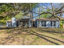 Charming single-story home with a stone facade and mature trees in a well-maintained yard at 181 Bernice Dr, Lawrenceville, GA 30045