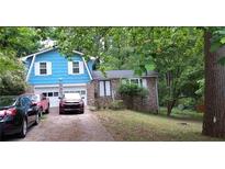 Charming home with brick facade, attached two-car garage, and a cozy, inviting front yard at 1207 Denison Dr, Clarkston, GA 30021