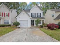 Charming two-story home with a manicured lawn, one-car garage, and inviting front porch at 240 Springbottom Ct, Lawrenceville, GA 30046