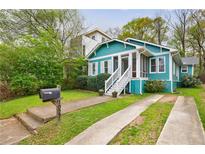 Charming home with a well-maintained lawn, a covered porch, and a private driveway at 1027 Kirkwood Se Ave, Atlanta, GA 30316