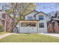 Charming two-story home featuring a manicured lawn, inviting front porch, and modern black-framed windows at 1456 S Gordon Sw St, Atlanta, GA 30310