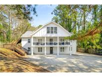 Stunning white two-story home with inviting double balconies and spacious driveway at 1596 Willowbrook Sw Dr, Atlanta, GA 30311