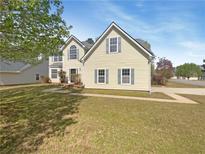 Charming two-story home with manicured lawn, mature shade tree, and delightful curb appeal at 501 Fable Ln, Canton, GA 30114