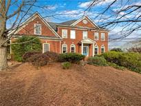 Attractive two-story brick home with manicured landscaping and a charming blue front door at 2123 Tigger Ne Trce, Marietta, GA 30066
