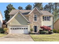 Charming two-story home featuring a stone facade, attached garage and a well-maintained lawn at 3707 Mcguire Nw St, Kennesaw, GA 30144