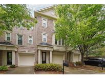 Brick townhome featuring attached garages and manicured landscaping at 3317 Regent Sw Pl, Atlanta, GA 30311