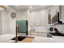 Bright kitchen boasts white cabinets, stainless steel appliances, and a sleek faucet at 850 Piedmont Ne Ave # 1206, Atlanta, GA 30308
