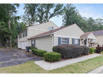 Charming townhouse with well-maintained landscaping and a neatly paved driveway at 1315 Old Coach Sw Rd, Marietta, GA 30008