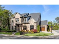 Beautiful two-story brick home with a well-manicured lawn and attached two car garage at 1720 Barclay Close Nw, Atlanta, GA 30318