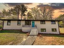 Charming two-story home with a bright blue front door and inviting curb appeal at 3340 Brenda Ln, Lithia Springs, GA 30122