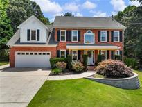 Charming brick home featuring a well-manicured lawn and traditional architectural details at 3965 Hamilton View Way, Dacula, GA 30019