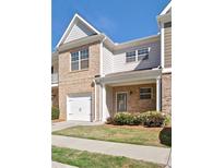 Charming townhome with brick facade, garage, and welcoming front porch at 234 Madison Ave, Acworth, GA 30102